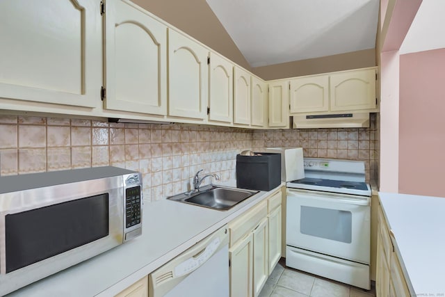 kitchen featuring white appliances, a sink, light countertops, under cabinet range hood, and backsplash