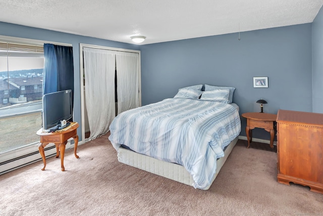 bedroom with carpet, a closet, and a textured ceiling