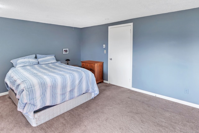 carpeted bedroom with baseboards