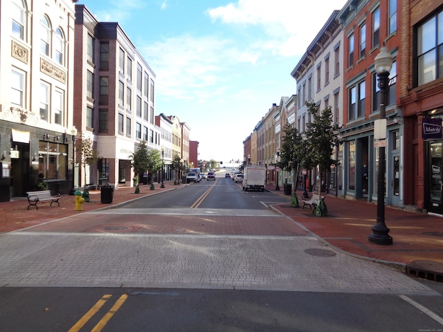 view of street featuring street lighting, curbs, and sidewalks