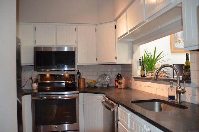 kitchen featuring stainless steel appliances, dark countertops, a sink, and backsplash