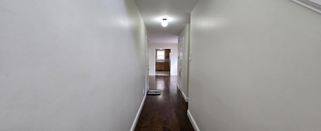 hall featuring dark wood-style floors and baseboards