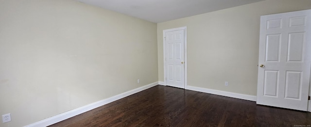 unfurnished bedroom featuring dark wood-style floors and baseboards