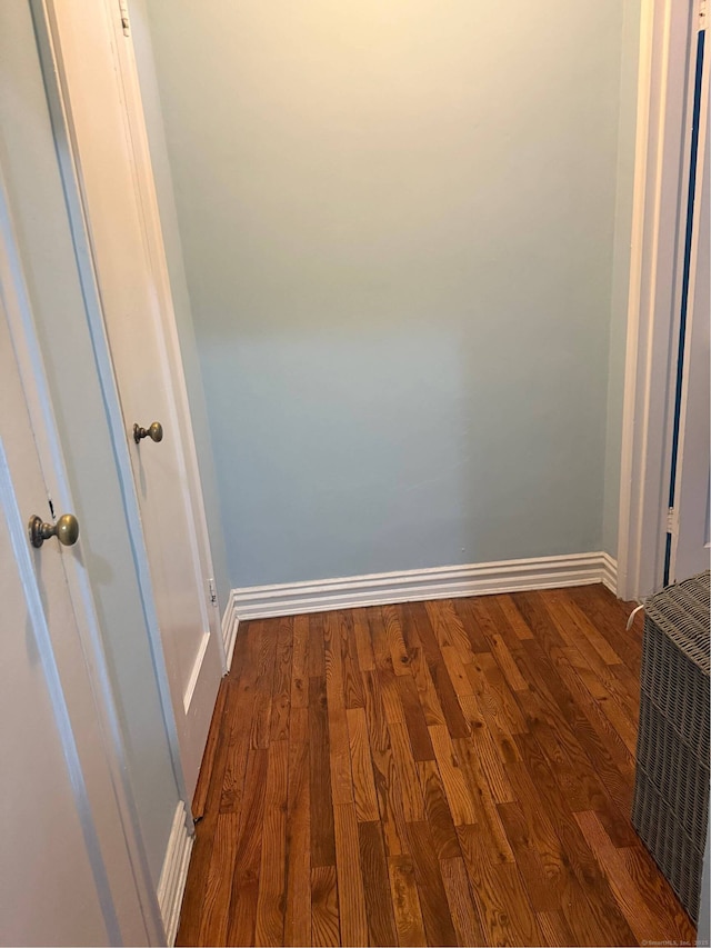 interior space with dark wood-type flooring and baseboards