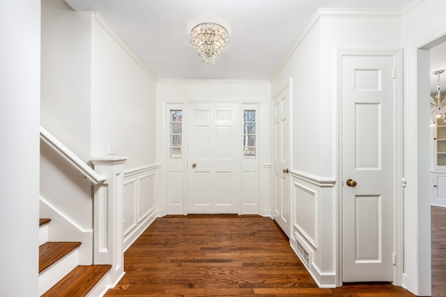 interior space featuring a chandelier, ornamental molding, stairway, and dark wood-style floors