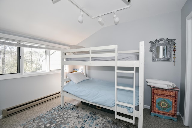 bedroom with lofted ceiling and a baseboard radiator