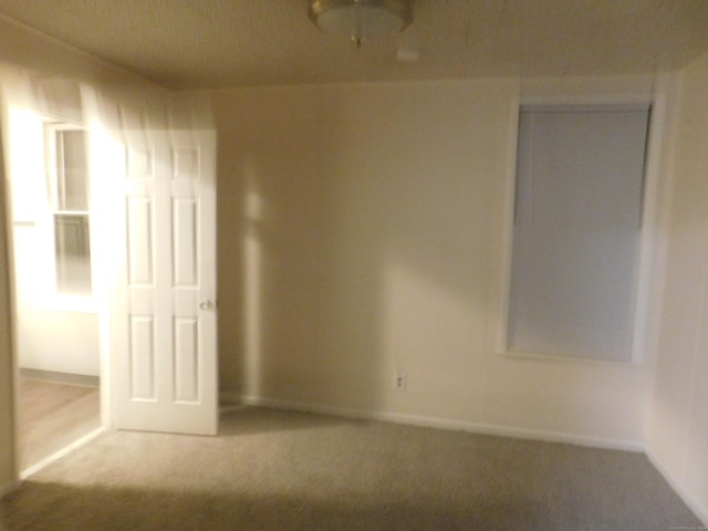 unfurnished bedroom featuring a closet, carpet flooring, and baseboards