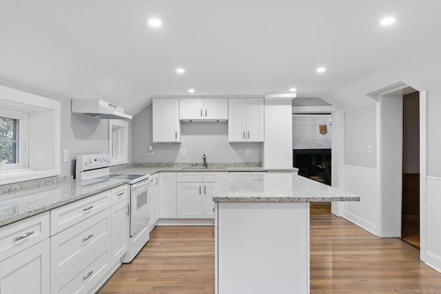 kitchen with white range with electric cooktop, lofted ceiling, a center island, under cabinet range hood, and a sink