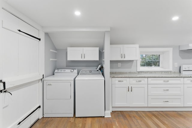 laundry area featuring a baseboard radiator, laundry area, washing machine and dryer, and light wood-type flooring