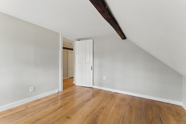 additional living space with vaulted ceiling with beams, hardwood / wood-style flooring, and baseboards