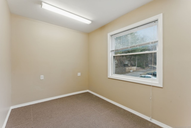 empty room with carpet and baseboards