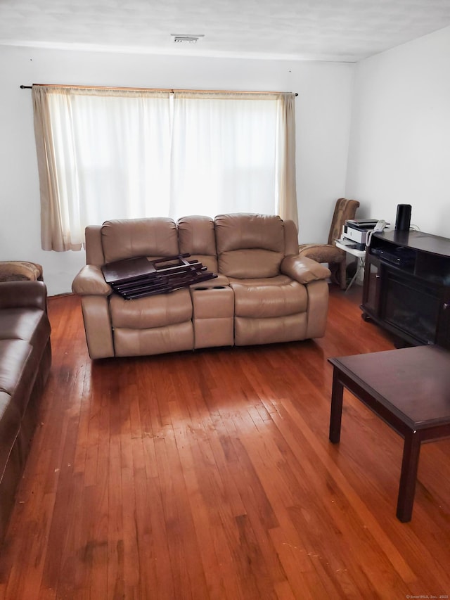 living room featuring hardwood / wood-style flooring and visible vents