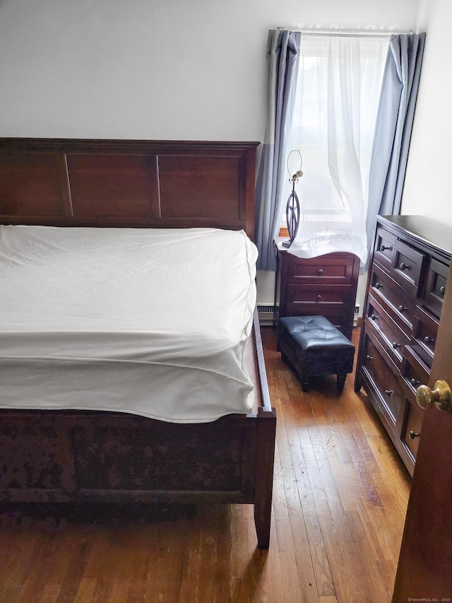 bedroom with wood-type flooring