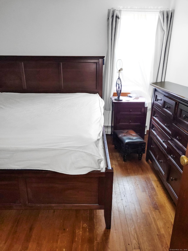 bedroom with hardwood / wood-style floors