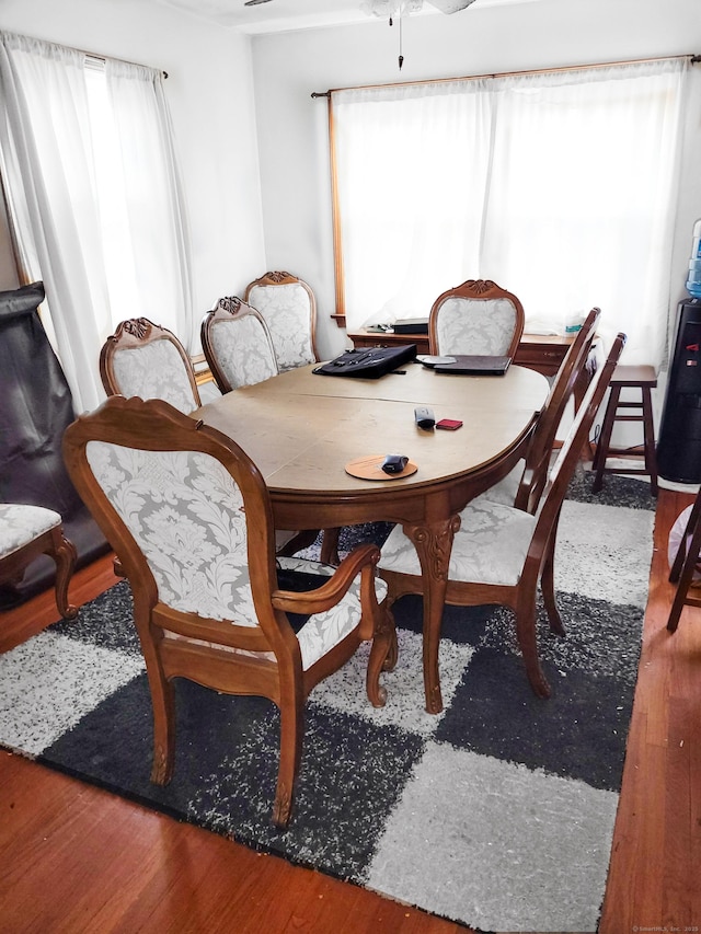 dining space with wood finished floors