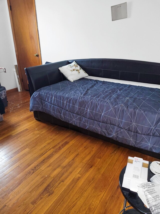 bedroom with hardwood / wood-style flooring