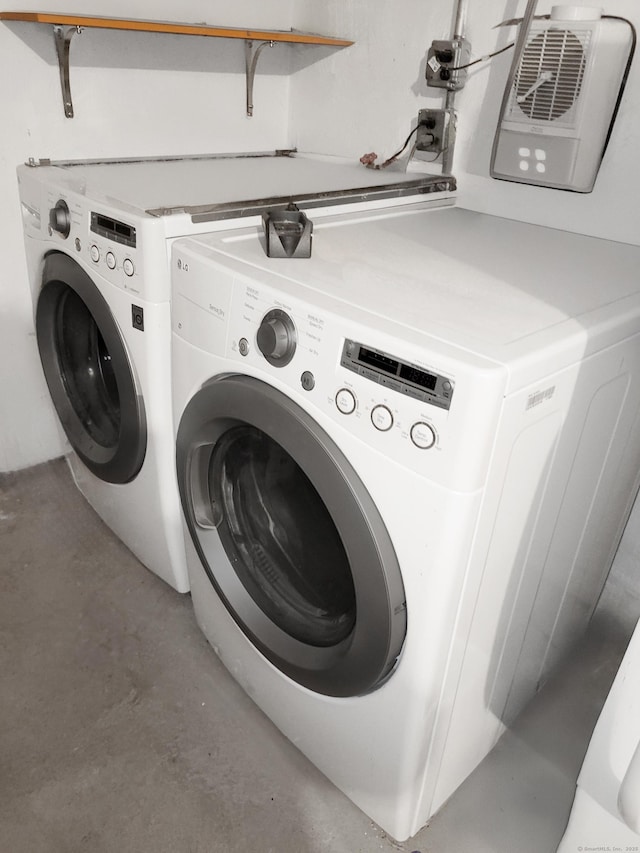 clothes washing area with laundry area and washer and clothes dryer