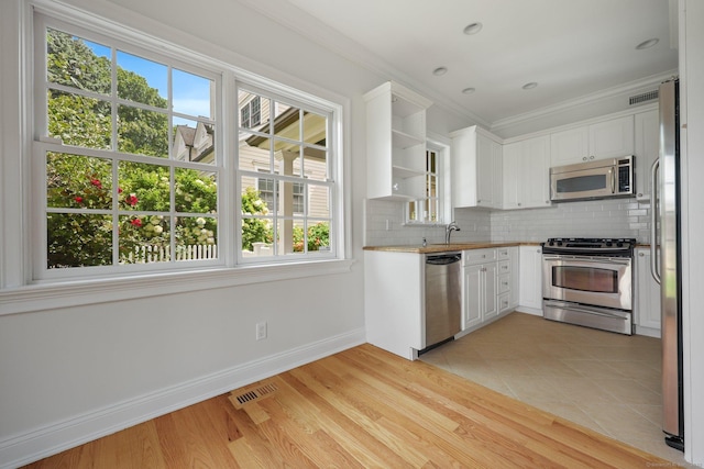 kitchen featuring visible vents, white cabinetry, appliances with stainless steel finishes, backsplash, and open shelves