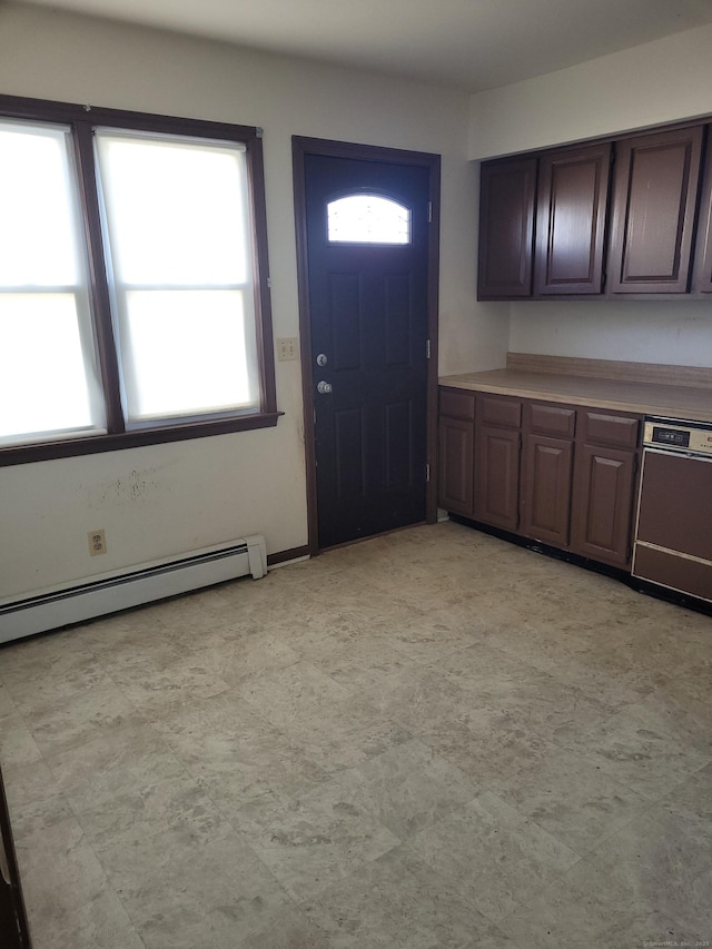 interior space with light floors, a baseboard heating unit, dark brown cabinets, and dishwasher