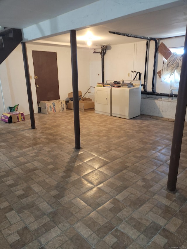 finished basement with brick patterned floor and washer and clothes dryer