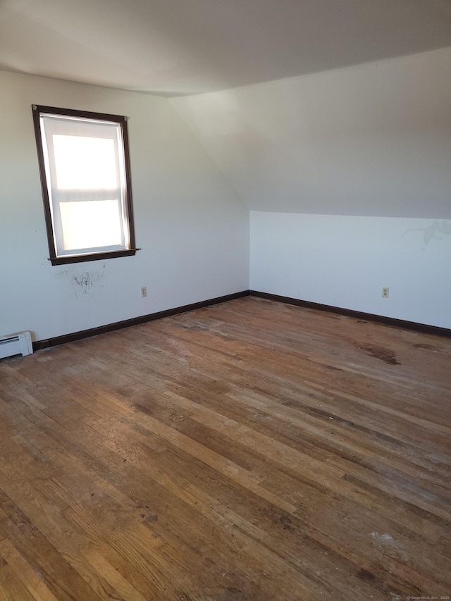 bonus room with lofted ceiling, dark wood finished floors, and baseboards