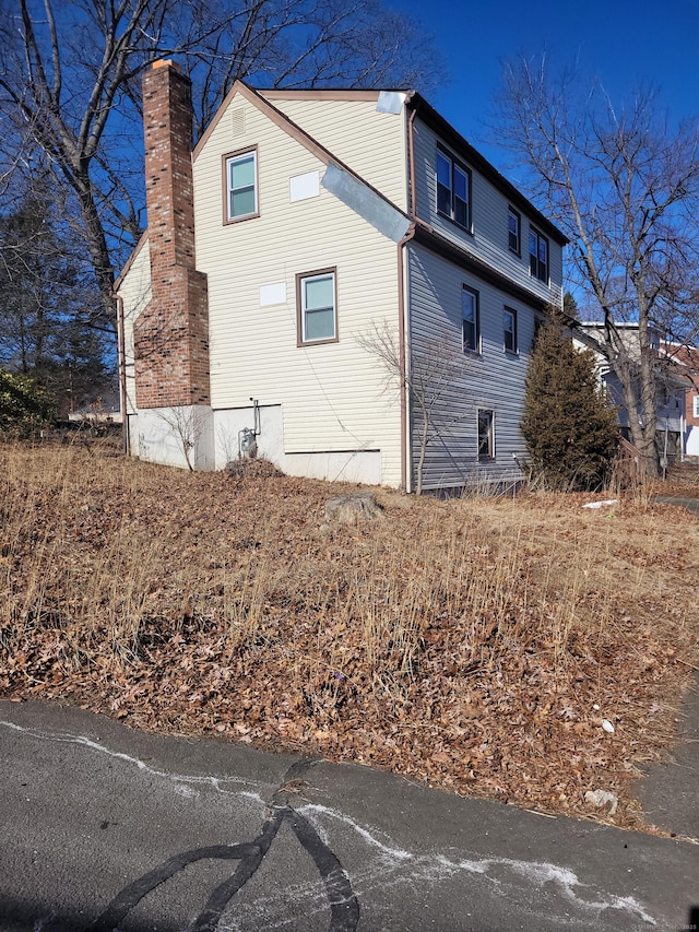 view of side of home featuring a chimney