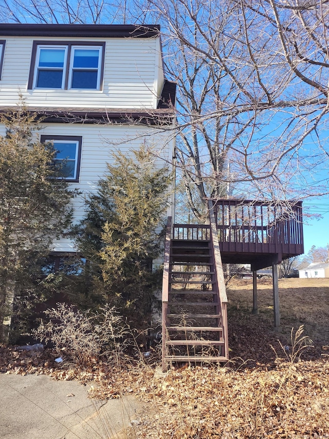 view of home's exterior with stairs and a deck