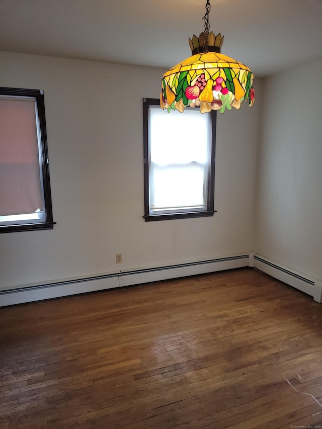 spare room featuring wood finished floors