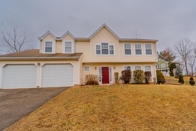 view of front of property with aphalt driveway, an attached garage, and a front lawn