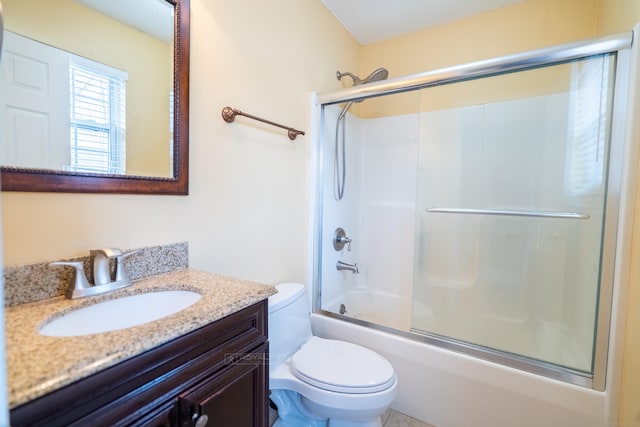 bathroom featuring enclosed tub / shower combo, toilet, and vanity