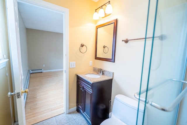 bathroom with baseboards, toilet, tile patterned floors, vanity, and a baseboard radiator