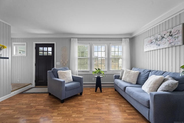 living room with a baseboard heating unit and wood finished floors