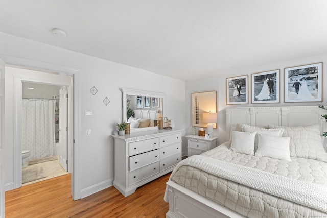 bedroom featuring light wood finished floors and baseboards