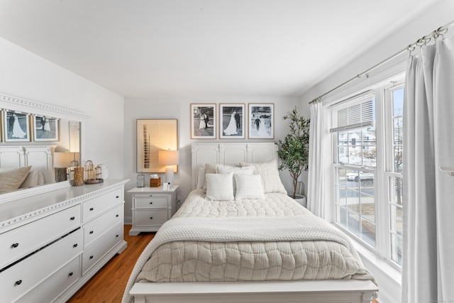 bedroom with dark wood-style flooring