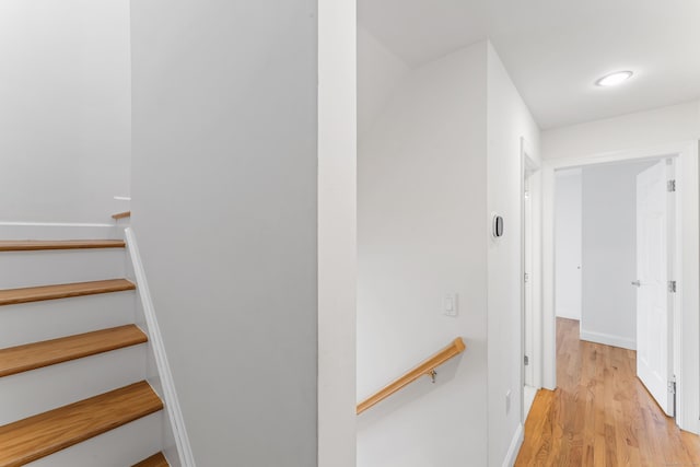 interior space featuring baseboards and wood finished floors