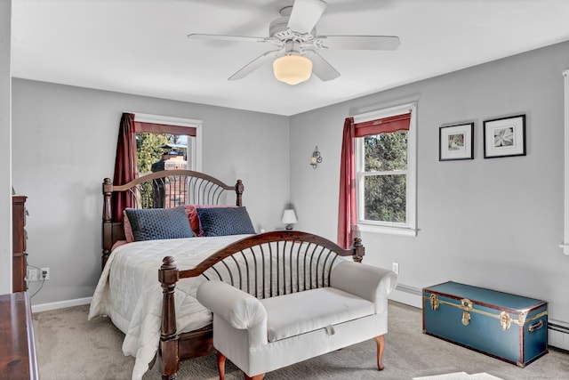 carpeted bedroom with a baseboard heating unit, a baseboard radiator, a ceiling fan, and baseboards