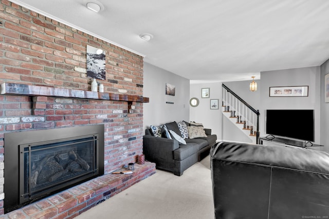 carpeted living area featuring a brick fireplace and stairs