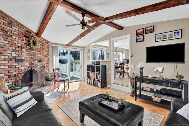 living room featuring baseboards, lofted ceiling with beams, ceiling fan, a textured ceiling, and a brick fireplace