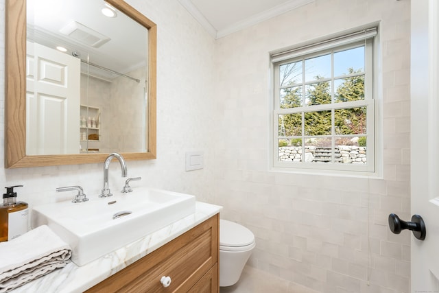 bathroom with toilet, visible vents, vanity, walk in shower, and crown molding