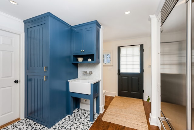 mudroom with baseboards, ornamental molding, and recessed lighting