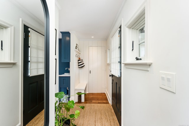 interior space with ornamental molding and wood finished floors