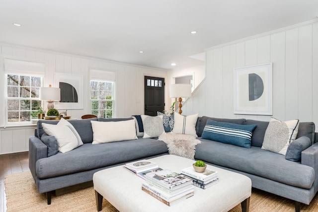 living room featuring recessed lighting, crown molding, and hardwood / wood-style flooring