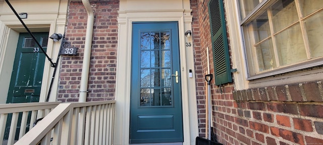 property entrance featuring brick siding