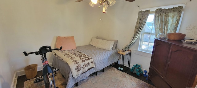 bedroom with baseboards and a ceiling fan