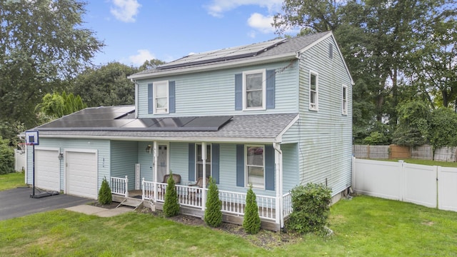 view of front of home with a garage, a front yard, covered porch, and driveway