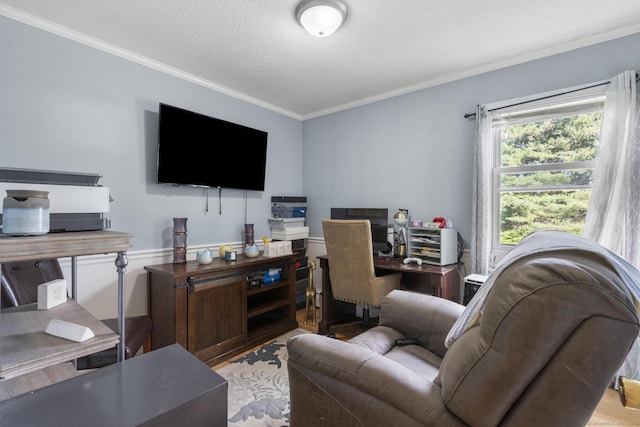 living area featuring ornamental molding, a textured ceiling, and wood finished floors