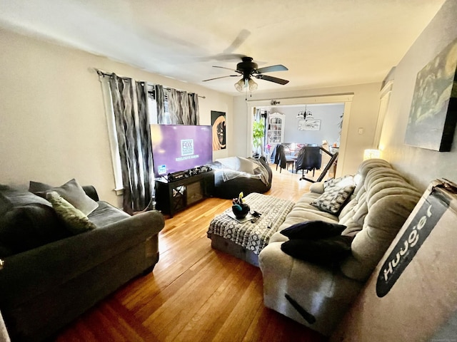 living area featuring hardwood / wood-style flooring and a ceiling fan