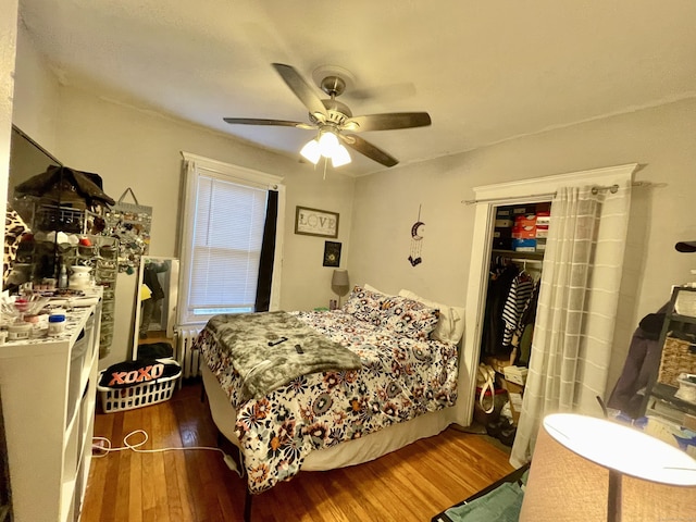 bedroom featuring radiator, ceiling fan, and wood finished floors