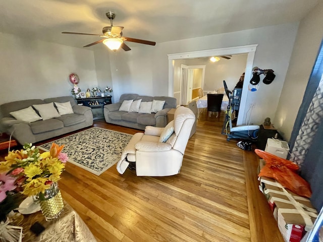 living room with a ceiling fan and wood finished floors