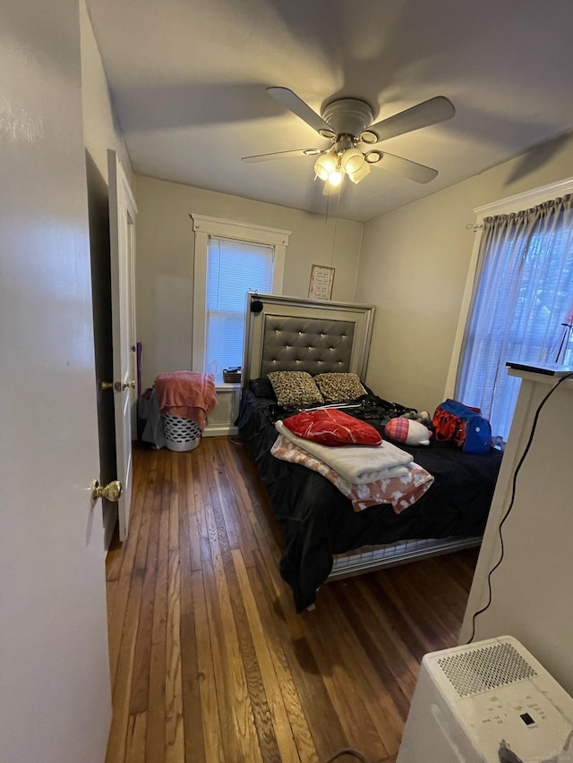 bedroom with ceiling fan and dark wood finished floors